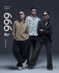 Three models wearing patterned and striped button-down shirts pose against a dark gray studio background, with text on the left reading 'PRINTED SHIRTS' and a large price overlay '₹996'.